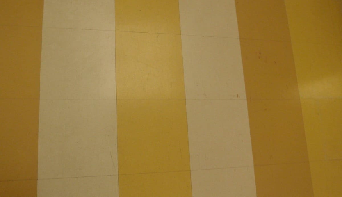 What causes yellow stains on vinyl flooring